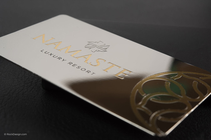 Premium metal business card with gold plated logo and custom etching on glossy silver mirror finish