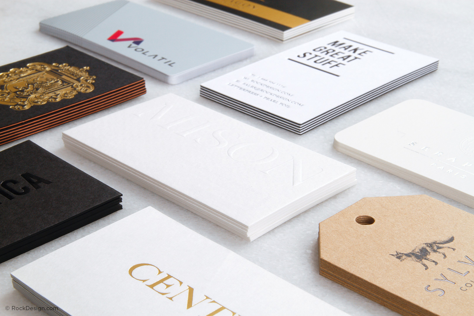 Multiple luxury business card styles displayed on table