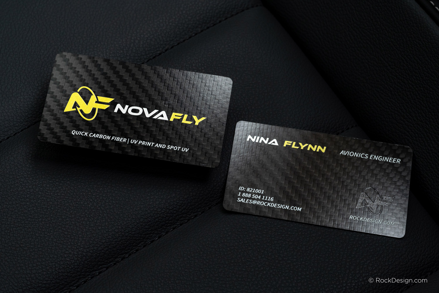 Modern carbon fiber business card with yellow logo and white text finished in UV print and spot UV.